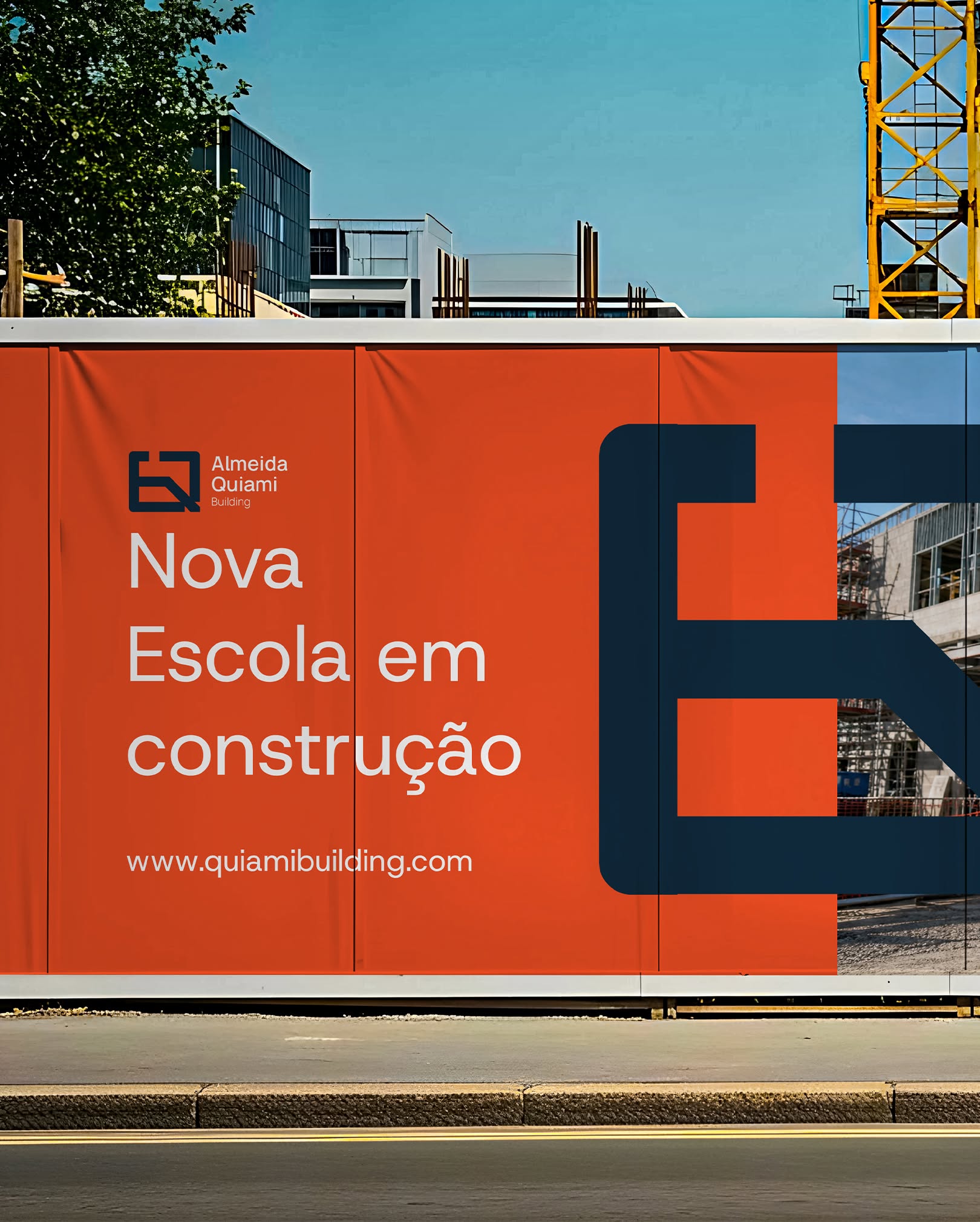 Almeida Quiami construction hoarding — Nova Escola em construção announcement in white on orange, with the giant navy monogram over a site photo