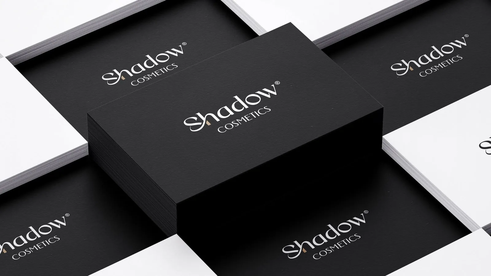 Shadow Cosmetics business cards — noir and ivory duplex stacks