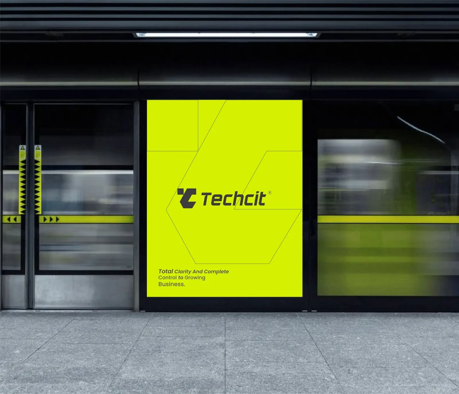 Techcit launch poster in a metro station — volt-green hexagonal poster with the monogram beside a passing train